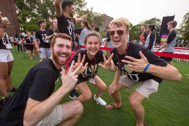 Students flash the VU hand sign at Founders Walk 2018. (Anne Rayner/Vanderbilt)