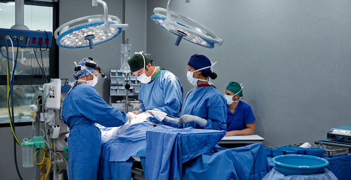 diverse surgeons operating on patient