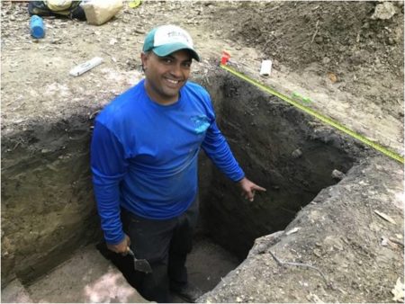 Jayur standing in excavated trench