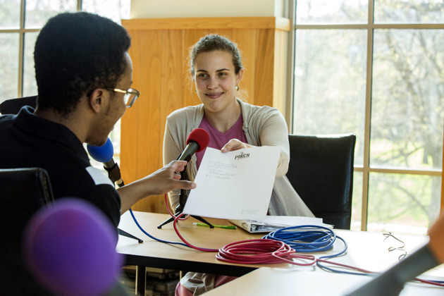 Cara Dees, MFA'14, shows Darius Cowan the poem she wrote about his 