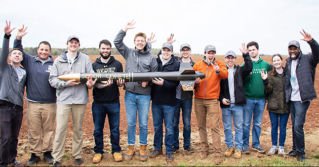 Vanderbilt Design Team celebrating the successful flight and recovery of their rocket SEÑOR COHETE at NASA Student Launch Competition: (L-R) Kurt Lezon, Spencer Kallor, Will Pagano, Dominic Ghilardi, Peyton Fite, Daniel Schneller, Nick Galioto, Taylor Parra, Jered Trujillo, Alex Byrd, Katie Hornbeck and Xavier Williams.