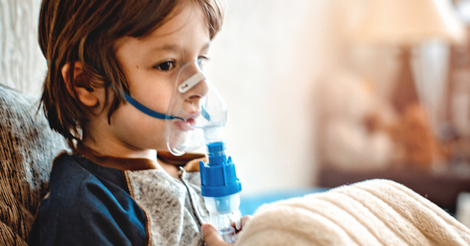 Child holds a mask vapor inhaler