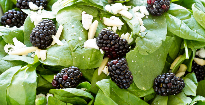 close up of blackberry spinach salad with feta cheese