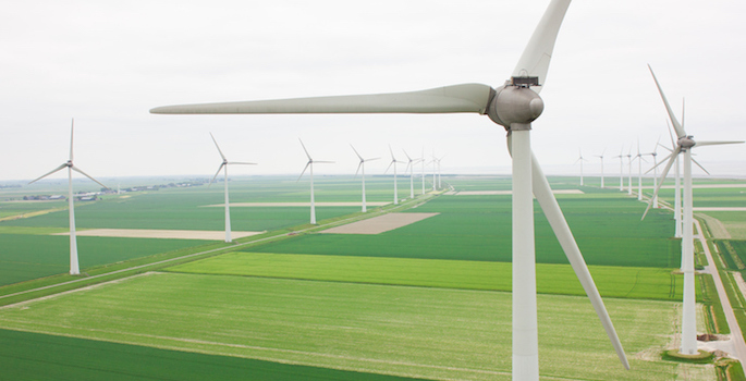 Aerial view of many wind turbines in a row