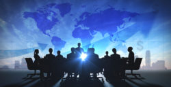 people in silhouette with a world map behind them