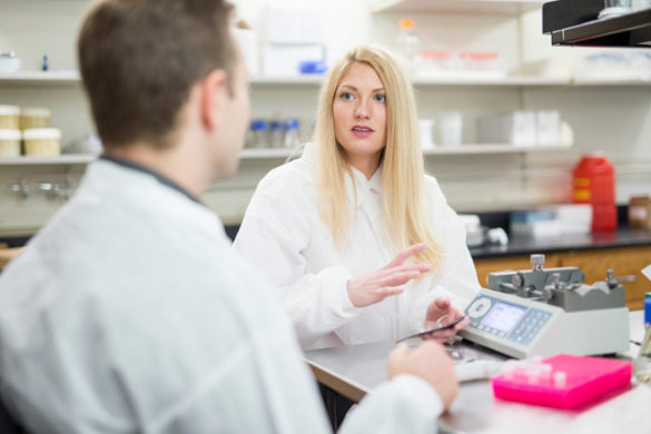 Sinead Miller, who recently earned her Ph.D. in biomedical engineering, discusses her company with mentor Robert Webster, associate professor of mechanical and electrical engineering. (John Russell/Vanderbilt)