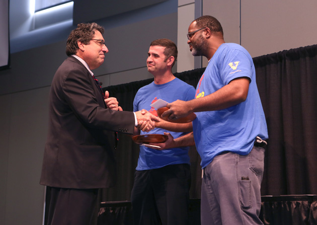 Chancellor Nicholas S. Zeppos presents Facilities' Joey Knight (center) and Jeff Bratton (right) with the Heart and Soul Staff Appreciation Award Nov. 1 at the Student Life Center. (Anne Rayner/Vanderbilt)