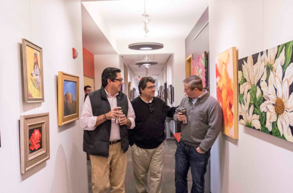 Conéxion Américas co-founder Jose Gonzalez (left) and Tennessee State Sen. Jeff Yarbro (right) join Chancellor Nicholas S. Zeppos on a tour through Casa Azafrán. (John Russell/Vanderbilt)