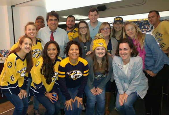 Chancellor Nicholas S. Zeppos and the winners of the #UnitedInGold social media contest at the Nashville Predators' season opener Oct. 10. (Vanderbilt University)