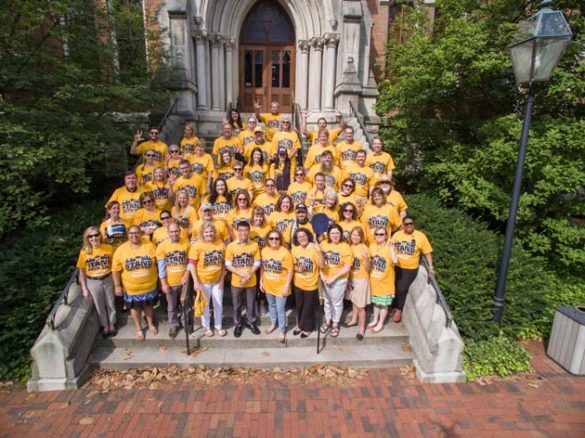 Members of the Division of Communications and the Office of the Chancellor wear their #UnitedInGold T-shirts on the steps of Kirkland Hall. (Daniel Dubois/Vanderbilt)