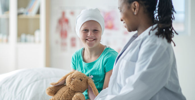 young bald girl in hat visiting her oncologist, an african american female doctor