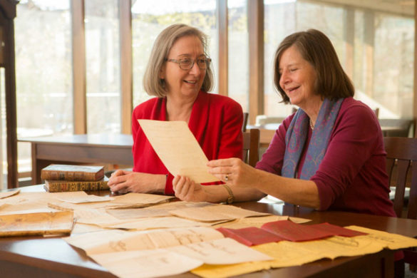 L-r: Valerie Hotchkiss, university librarian, and Paula Covington, Latin American bibliographer, examine rich materials from the J. Leon Herlguera Collection of Colombiana. (Anne Rayner/Vanderbilt University)