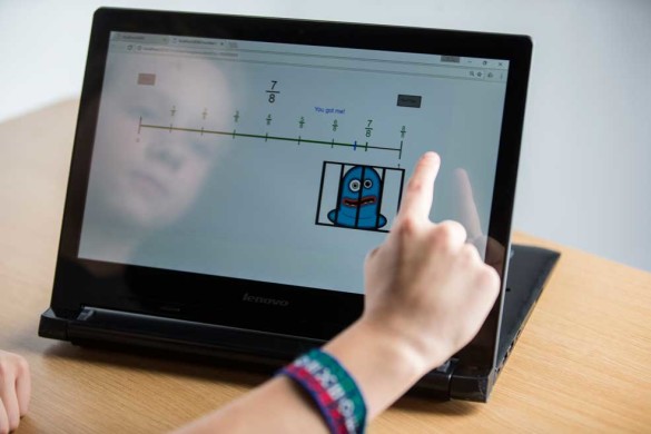 A fifth grader tests Lisa Fazio's "Catch the monster with Fractions" computer game. (Joe Howell/Vanderbilt)