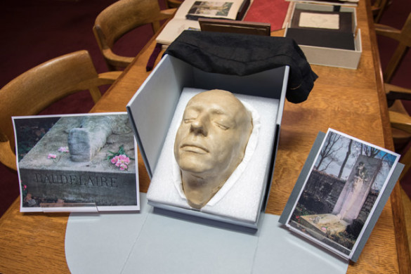 Charles Baudelaire's death mask framed by pictures of his grave. (Jon Erickson/Vanderbilt University)