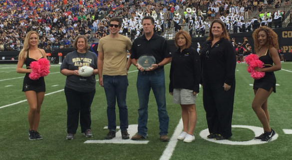 John Compton, program coordinator for Rooted Community Health, accepted this year's "Greenest Group on Campus" award from Waste Management's Tim Wells. (Vanderbilt University)