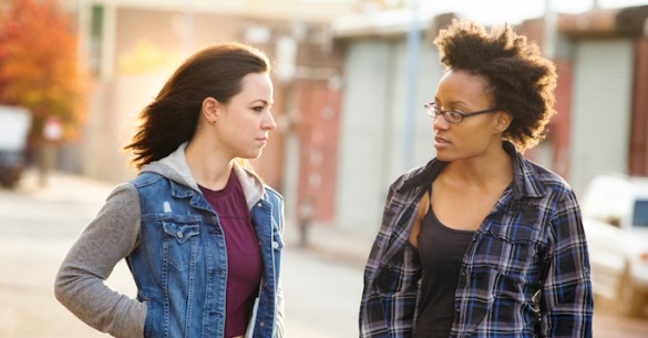 White and black young women have a serious talk