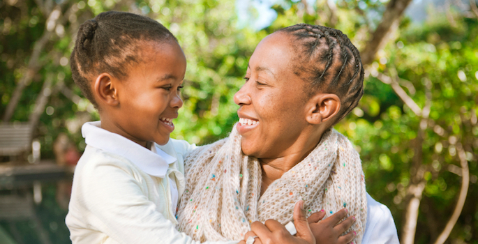 african american mom and toddler daughter laughing