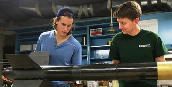 students with rocket in lab