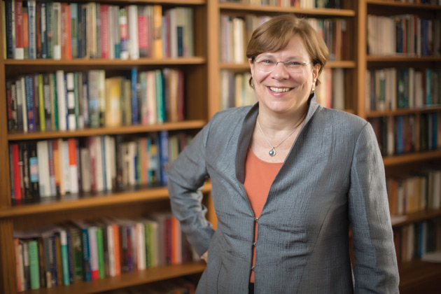 History Professor Lauren Benton staning in front of bookcase