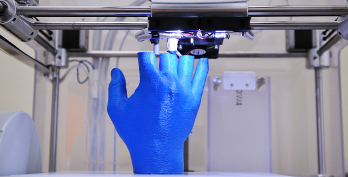 3D printer producing a blue colored hand