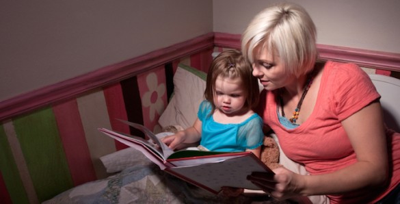 mom reading bedtime story to toddler girl