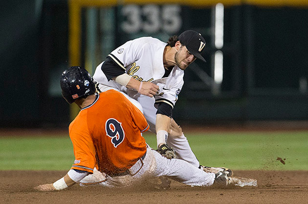Short stop Dansby Swanson tags a player out in Game 3 of the 2015 College World Series.