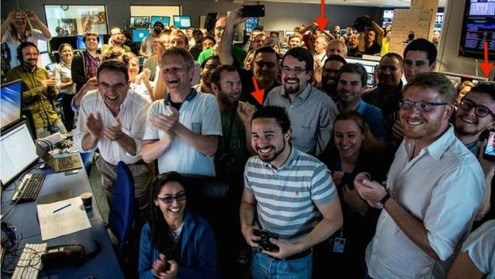 group shot of researchers cheering in control room
