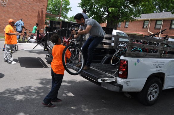 Dawei Li, a SEMO student intern, helps unload bicycles being donated to the Edgehill Bike Club.