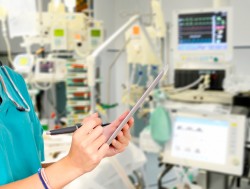 nurse marking chart in intensive care unit