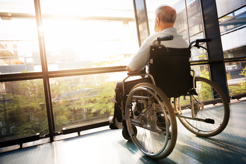 elderly man in wheelchair in skilled nursing facility