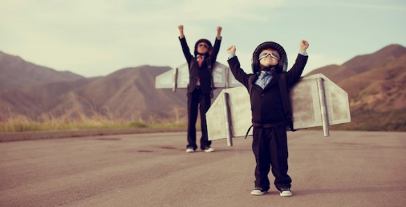 two cute kids wearing homemade jetpacks in the desert