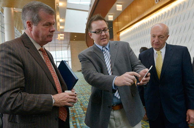 Nashville Mayor Karl Dean (left) and Vanderbilt's Jules White (center), assistant professor of electrical engineering and computer science, demonstrate the wayfinding app at the Music City Center. (Dipti Vaidya)