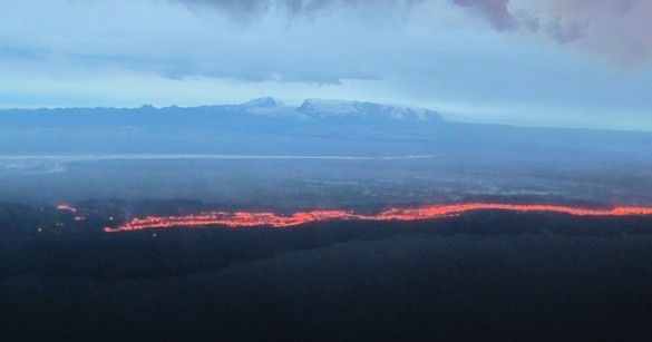 mountain with flowing lava in foreground