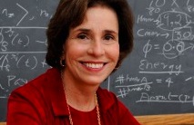 Carol Hall sitting in front of blackboard