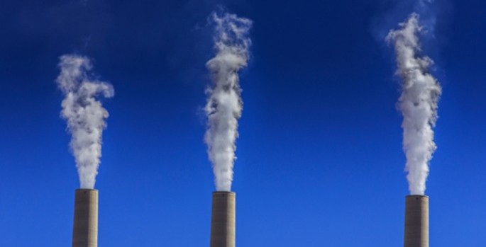 smokestacks pouring smoke into the sky