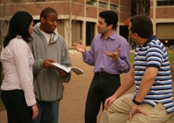 Stassun chatting with diverse group of students