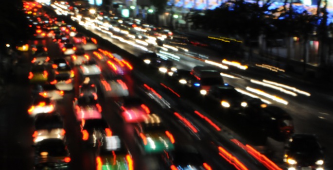 long line of headlights and taillights in motion