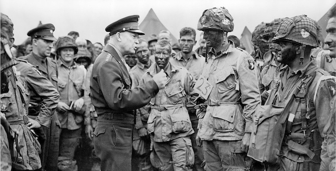 Eisenhower surrounded by troops