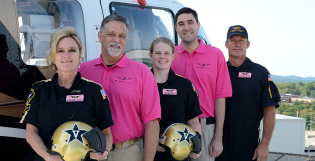 Vanderbilt LifeFlight's Marsha Roberts, Randy Hughes, Leah Smith, Kevin Mobley and Bric Baker show the pink flight name badges and shirts that LifeFlight staff will wear during the month of October. (Vanderbilt University)