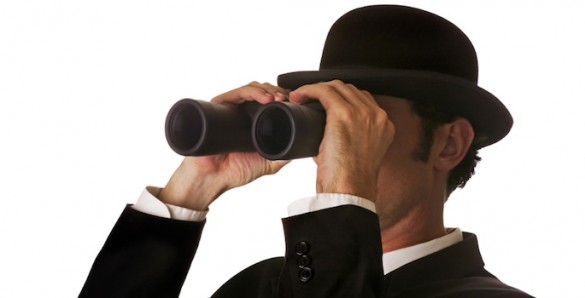 man looking through binoculars