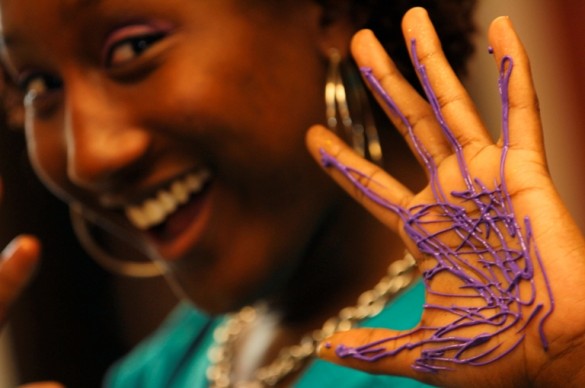 Smiling girl with painted hand