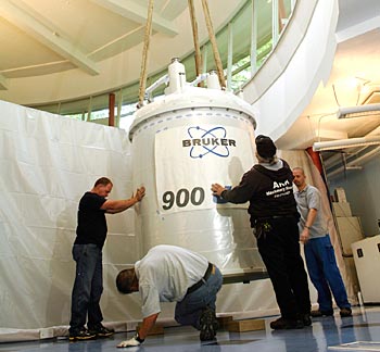 Workers install the new 7.5-ton magnet in the Biomolecular Nuclear Magnetic Resonance Facility. The magnet is part of an ultra-high field NMR spectometer that will be among the most powerful in the nation. (Anne Rayner / Vanderbilt)