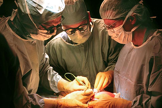 Dr. Noel Tulipan, Dr. Kyle Mangels and Dr. Joseph Bruner perform surgery on a fetus with spina bifida at Vanderbilt University Medical Center in 1998. (File photo by Anne Rayner/Vanderbilt)