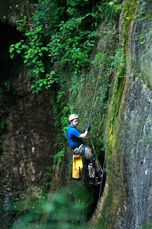 Caving expert John Hickman, who accompanies Bachmann on his underground expeditions, repels down to the entrance of the Snail Shell Cave near Murfreesboro, Tenn.