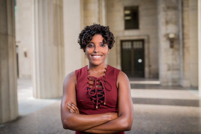 Assistant Professor of Political Science Sharece Thrower standing in front of War Memorial Building