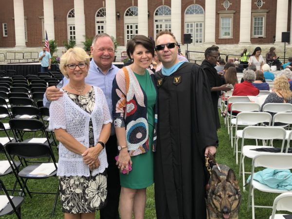 James Boehm (far right) with his parents and wife on Commencement day 2019.