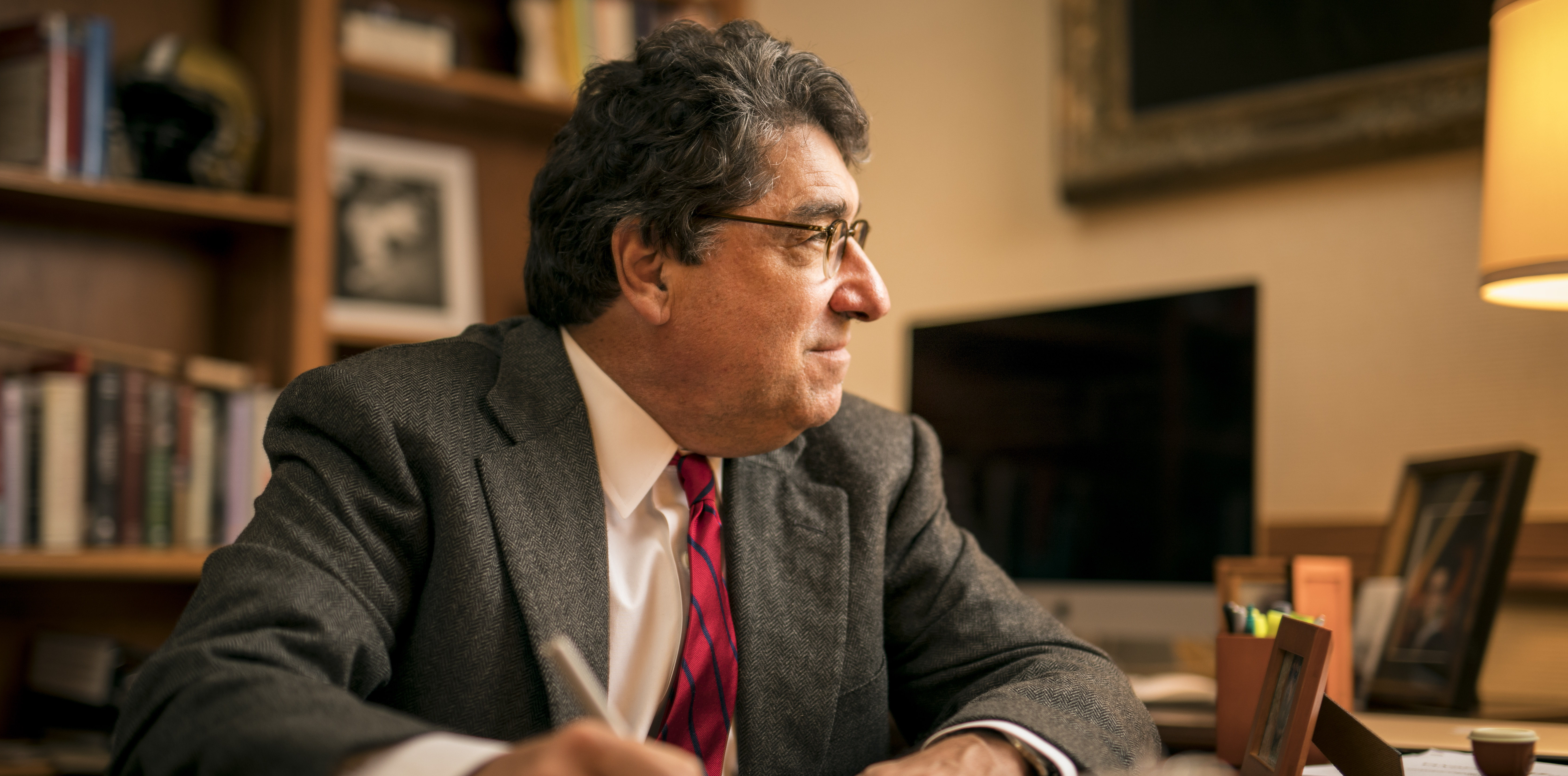 Photograph of Chancellor Nicholas S. Zeppos sitting at his desk, looking away from the camera, in his office in Kirkland Hall.