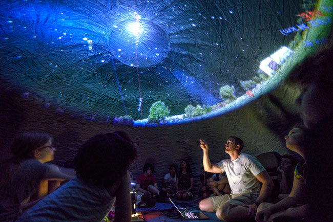 Outreach astronomer Billy Teets conducts a planetarium show for campers at Vanderbilt Dyer Observatory. (Joe Howell/Vanderbilt)