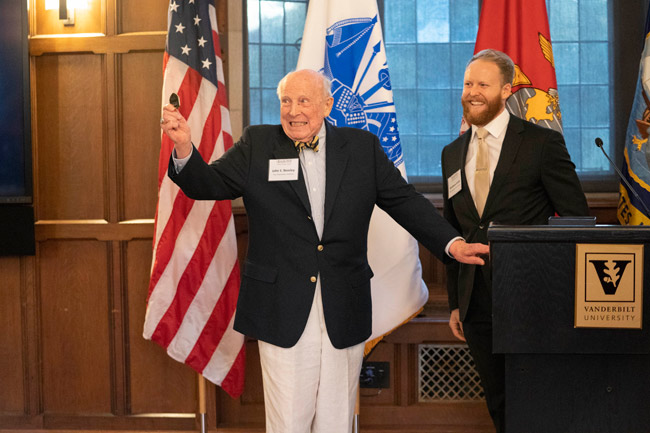 Vanderbilt alumnus and longtime administrator John S. Beasley II (left) receives a Bass Military Scholar challenge coin from inaugural Beasley Scholarship recipient Matthew Smith, a School of Medicine student and former Navy SEAL. (Joe Howell/Vanderbilt)