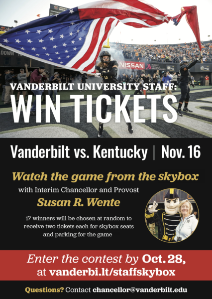 A Vanderbilt football player waves an American flag and Interim Chancellor and Provost Susan R. Wente with Mr. C.